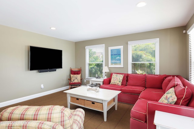 living area with baseboards, recessed lighting, and a healthy amount of sunlight