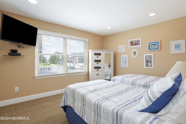 bedroom featuring light carpet, recessed lighting, and baseboards