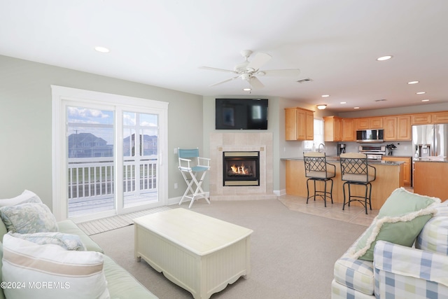 living room with a healthy amount of sunlight, light carpet, visible vents, and recessed lighting