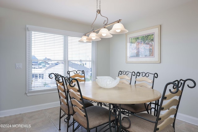 dining area featuring baseboards and light tile patterned floors