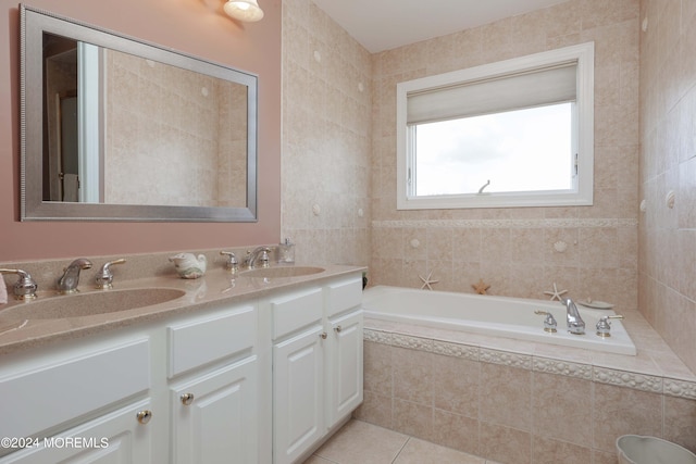 full bath featuring double vanity, a garden tub, a sink, and tile patterned floors