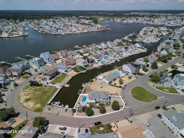 birds eye view of property with a water view and a residential view