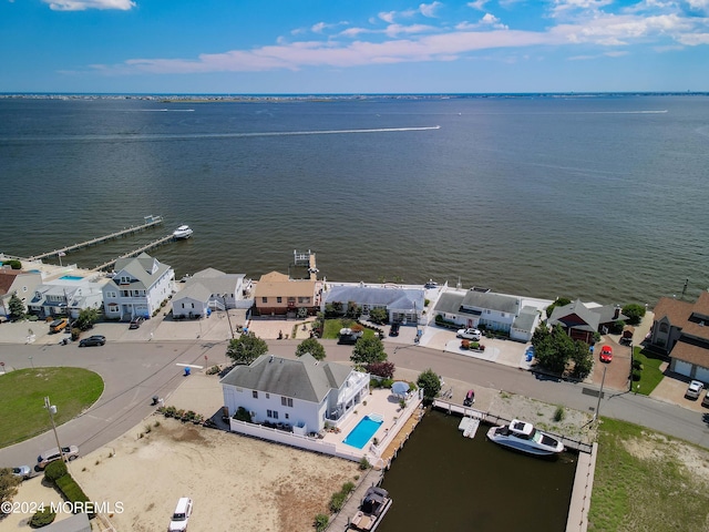 drone / aerial view with a residential view and a water view