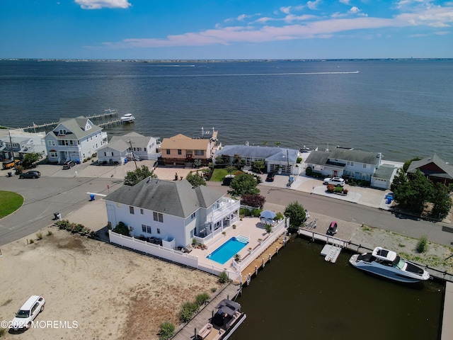 drone / aerial view with a water view and a residential view