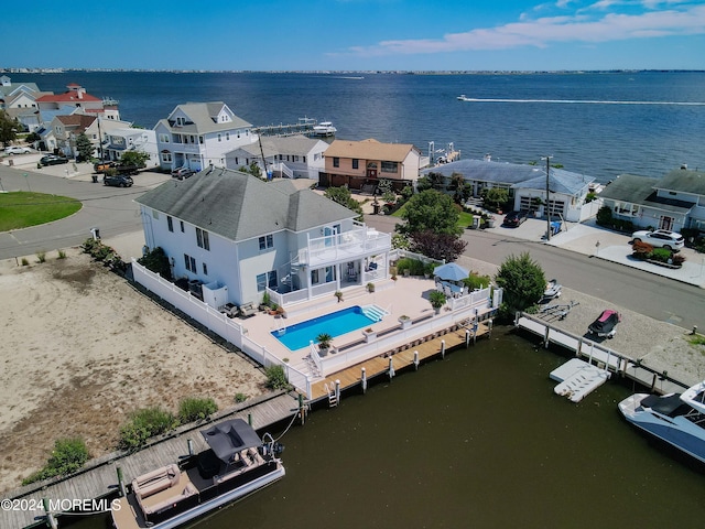 birds eye view of property with a water view and a residential view