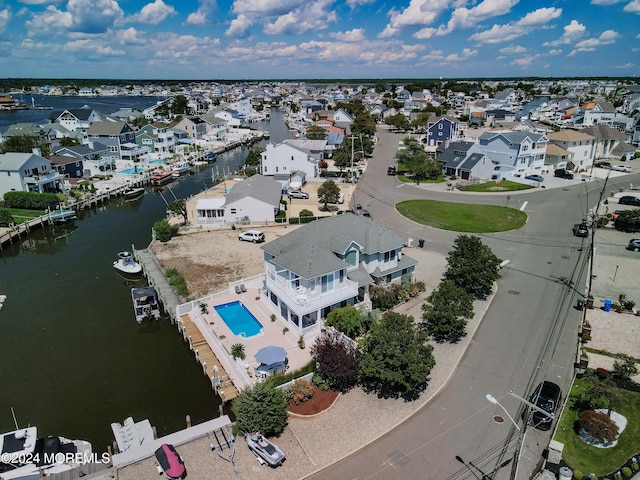 drone / aerial view with a water view and a residential view