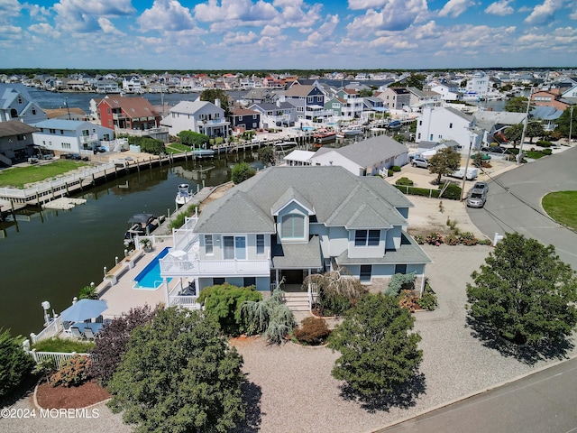 bird's eye view featuring a water view and a residential view