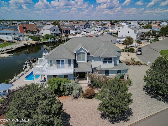 bird's eye view with a water view and a residential view