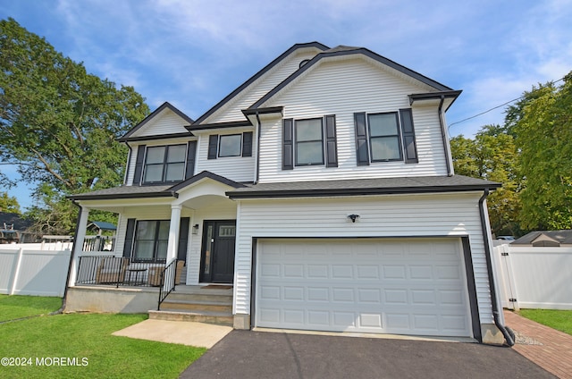 view of front of property with a porch and a garage