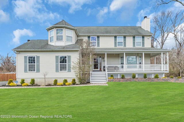 view of front of house featuring covered porch and a front yard