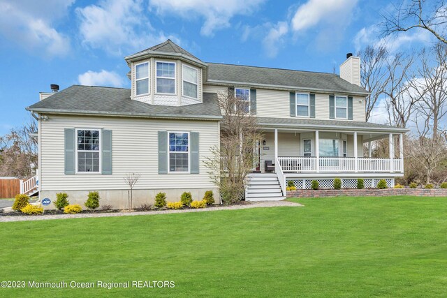 view of front facade featuring covered porch and a front lawn