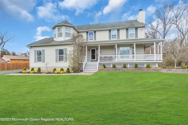 view of front of house featuring covered porch and a front lawn