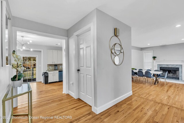 hall featuring a chandelier and light wood-type flooring