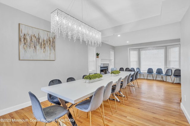 dining space with an inviting chandelier and light wood-type flooring