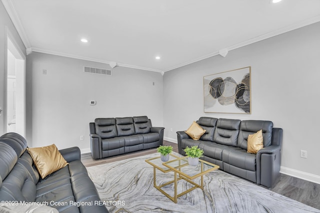 living room with crown molding and hardwood / wood-style flooring