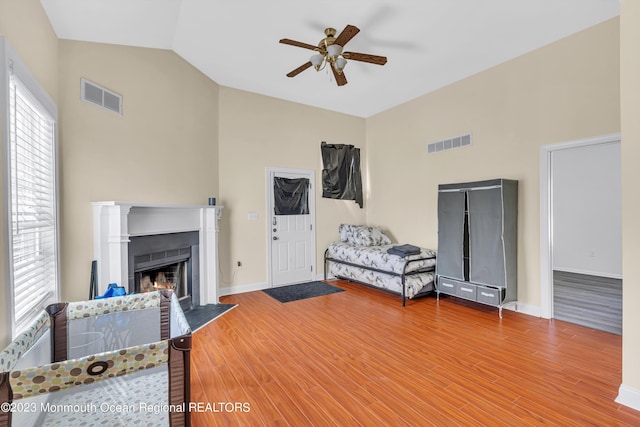 bedroom with lofted ceiling, hardwood / wood-style floors, and ceiling fan