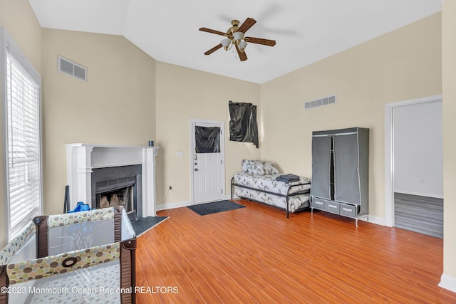 bedroom featuring hardwood / wood-style flooring, lofted ceiling, and ceiling fan