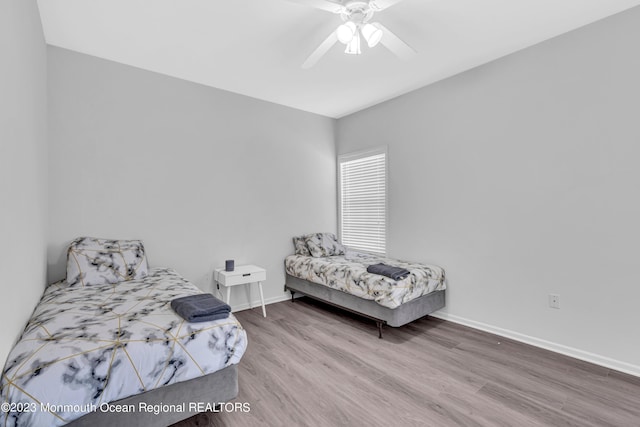 bedroom with hardwood / wood-style floors and ceiling fan