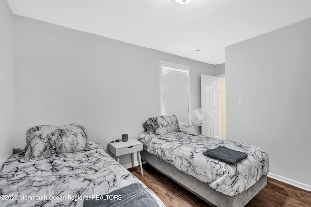 bedroom with dark hardwood / wood-style flooring