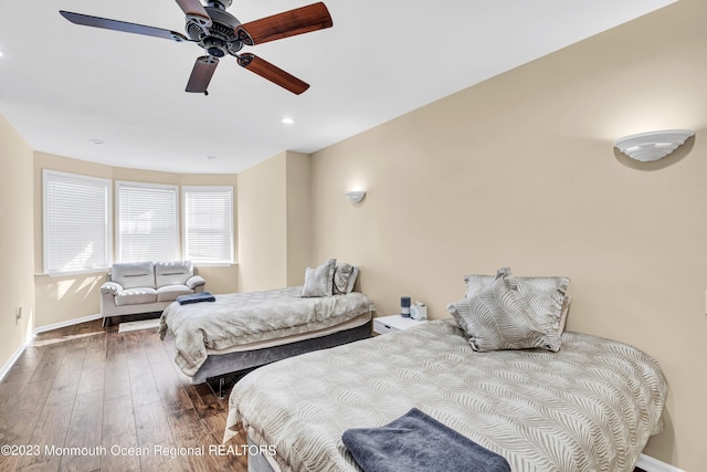 bedroom with ceiling fan and hardwood / wood-style floors