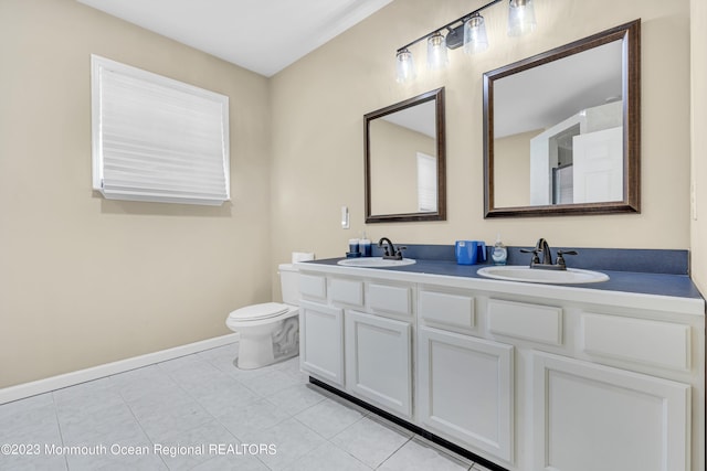 bathroom with vanity, tile patterned floors, and toilet