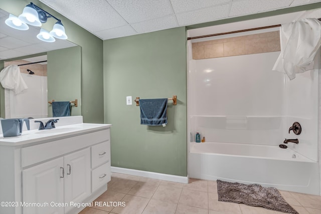 bathroom with vanity, tub / shower combination, tile patterned flooring, and a drop ceiling