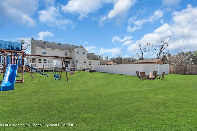 view of yard with a playground and a fire pit