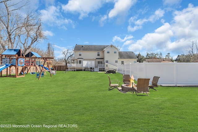 view of yard with an outdoor fire pit and a playground