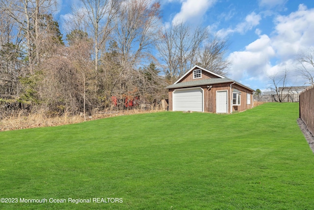 view of yard with a garage and an outdoor structure