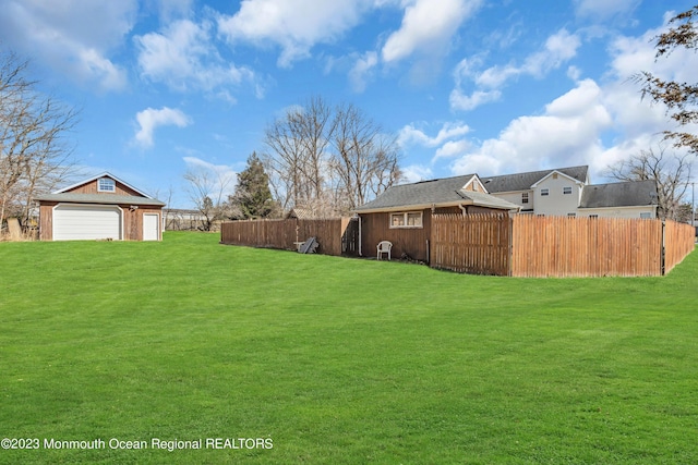 view of yard with a garage and an outdoor structure