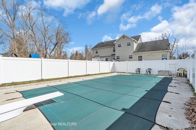 view of pool featuring a diving board