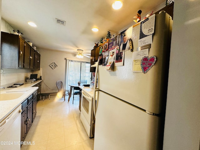 kitchen featuring white appliances, sink, ceiling fan, tasteful backsplash, and dark brown cabinetry