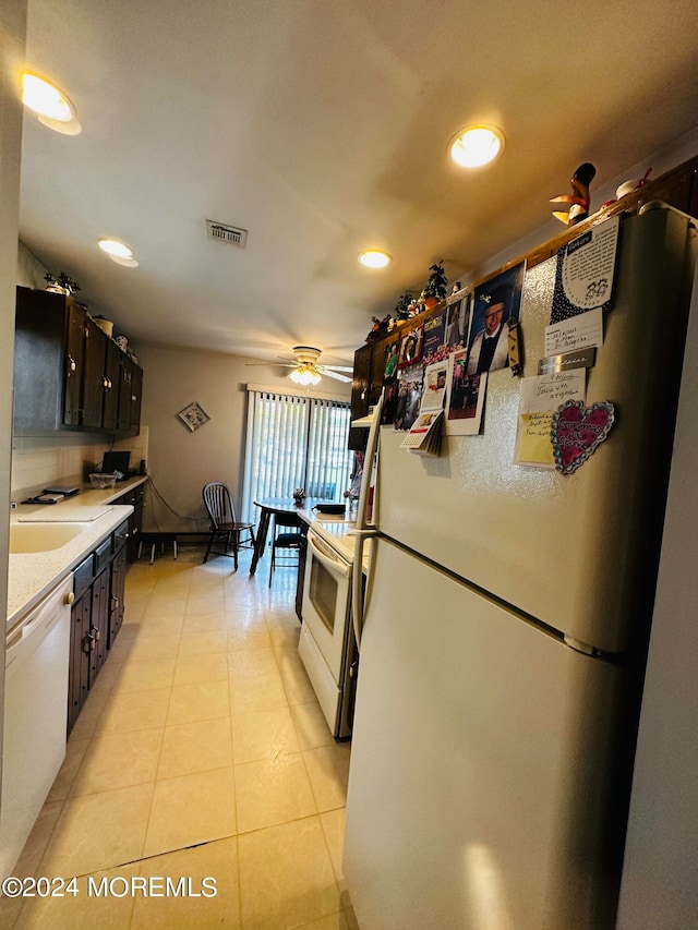 kitchen featuring ceiling fan, white appliances, decorative backsplash, dark brown cabinets, and light tile patterned floors