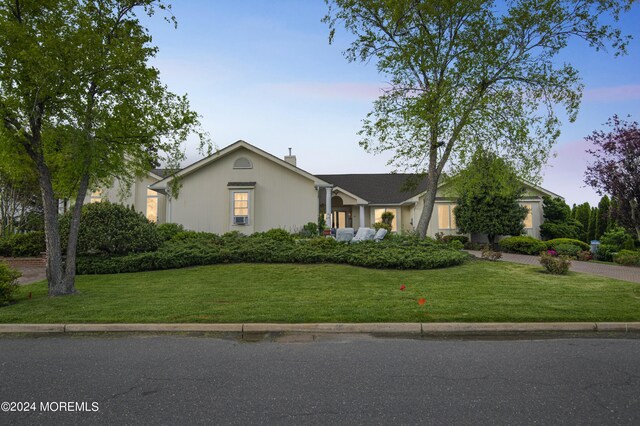 single story home featuring a yard