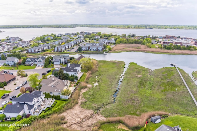 birds eye view of property featuring a water view and a residential view