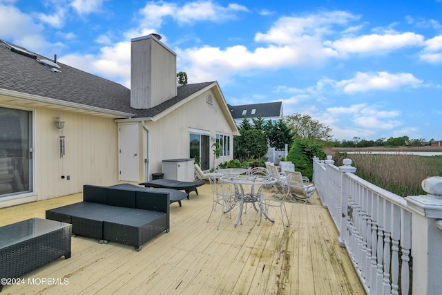 wooden deck with outdoor dining area and an outdoor living space