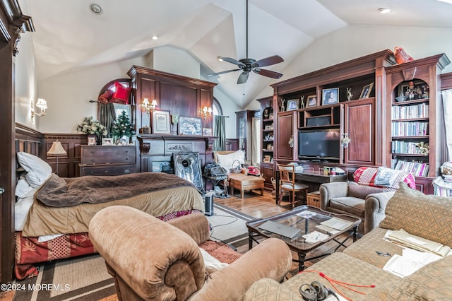 living room with vaulted ceiling, ceiling fan, and light wood-style floors