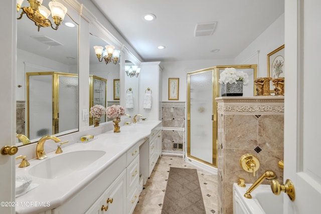 full bathroom with a sink, visible vents, tile walls, a shower with door, and an inviting chandelier