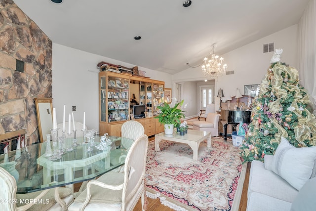 living room with visible vents, vaulted ceiling, and a chandelier