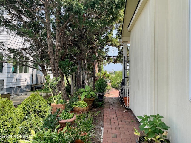 view of side of home with a patio area and a vegetable garden