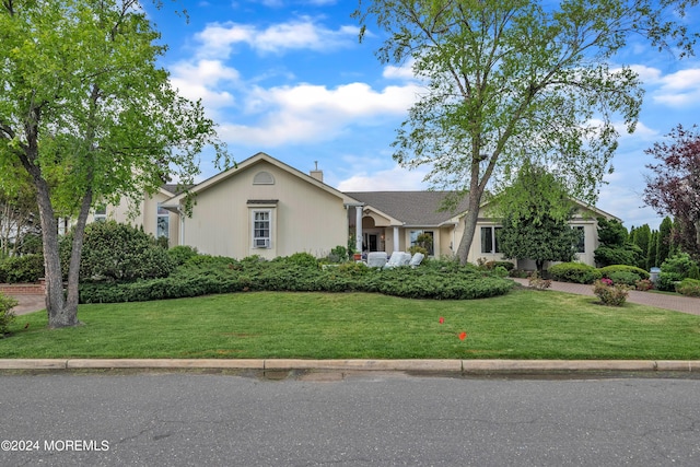 view of front of home featuring a front yard and a chimney