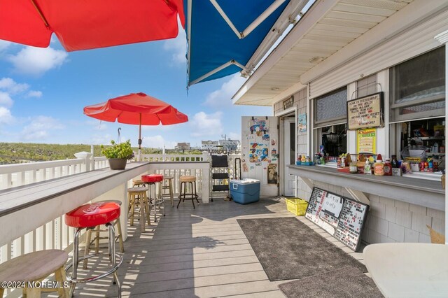 wooden terrace featuring a bar