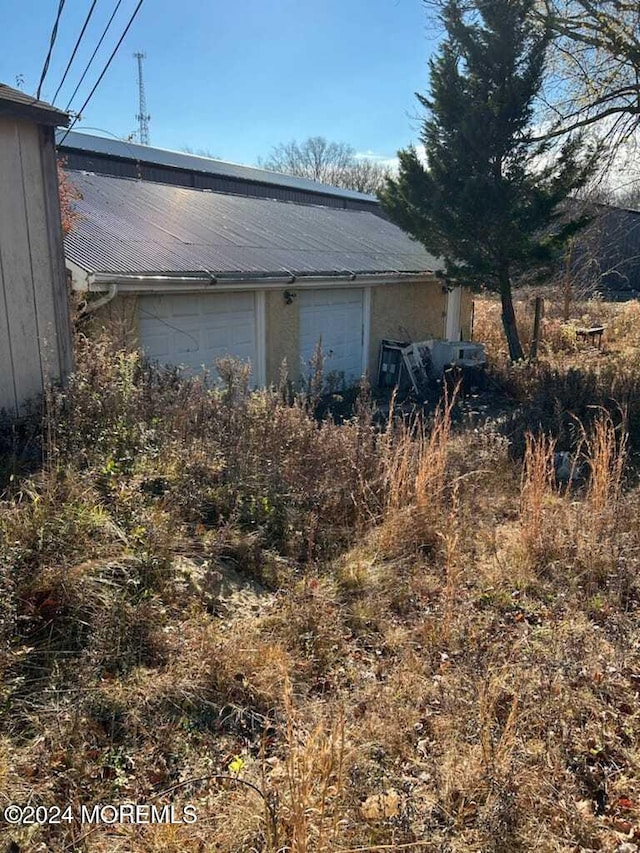 view of side of property with a garage