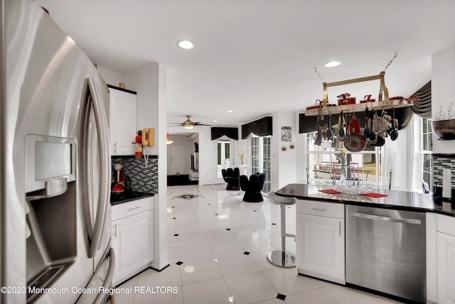 1969 Whitesville Rd, Toms River, NJ 08755 - kitchen with backsplash, light tile patterned floors, appliances with stainless steel finishes, and white cabinetry
