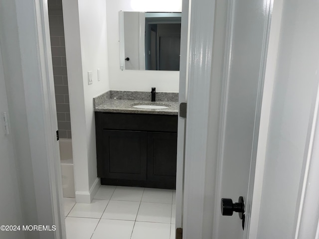 bathroom with tile patterned floors and vanity