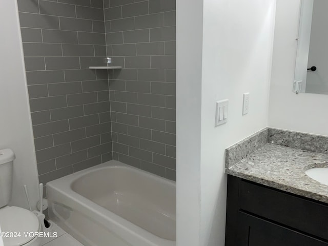 full bathroom featuring toilet, tile patterned floors, vanity, and  shower combination