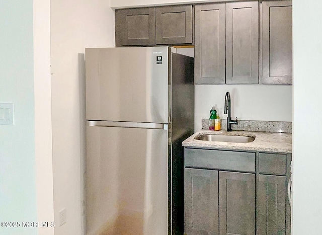 kitchen with stainless steel fridge and sink