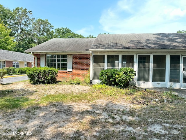 view of front facade with a sunroom