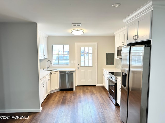 kitchen with dark hardwood / wood-style floors, sink, stainless steel appliances, and white cabinets