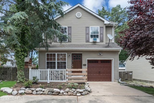 view of front of property with cooling unit and a garage